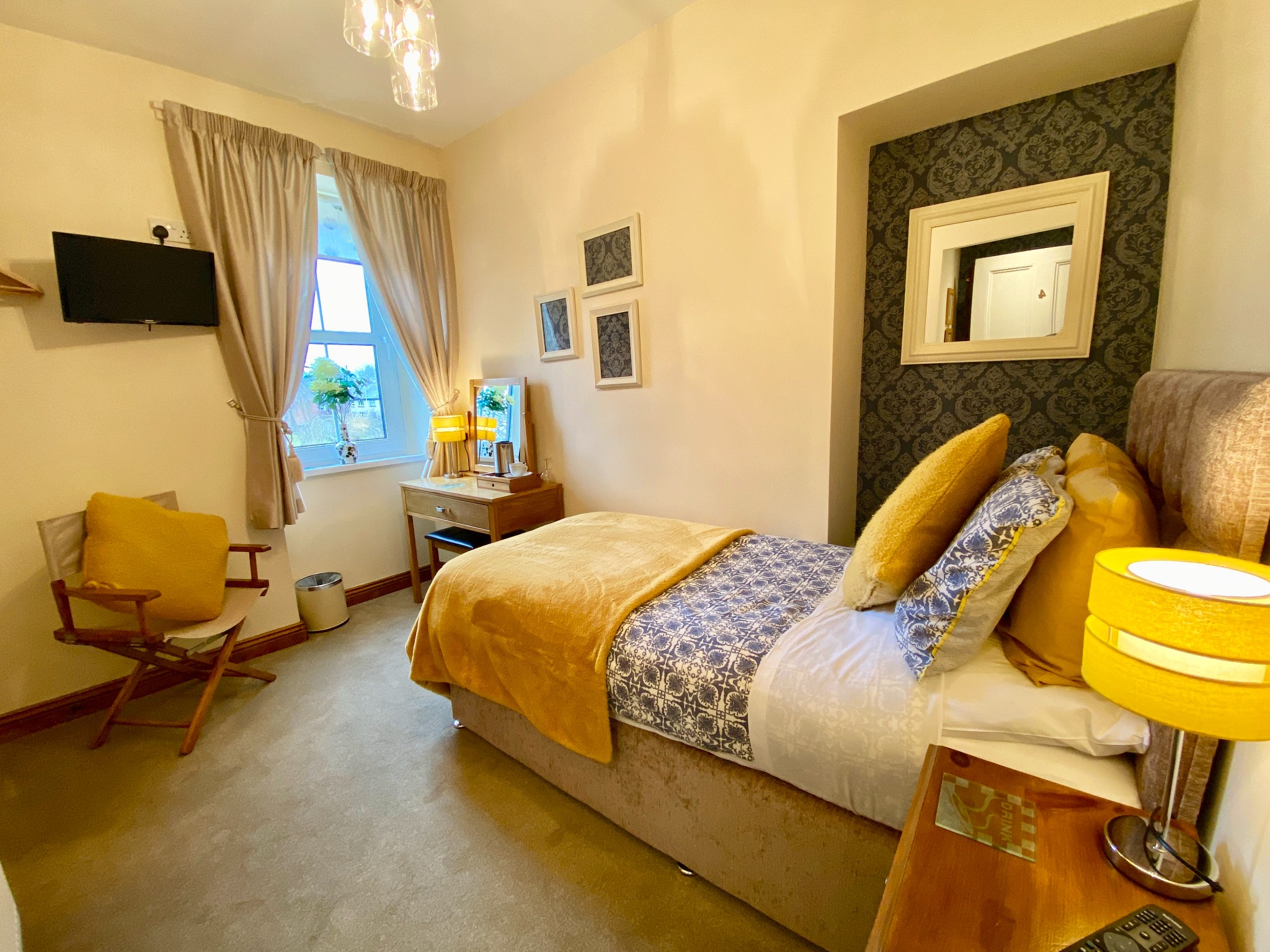 Warm gold guest bedroom at Glendale Guesthouse